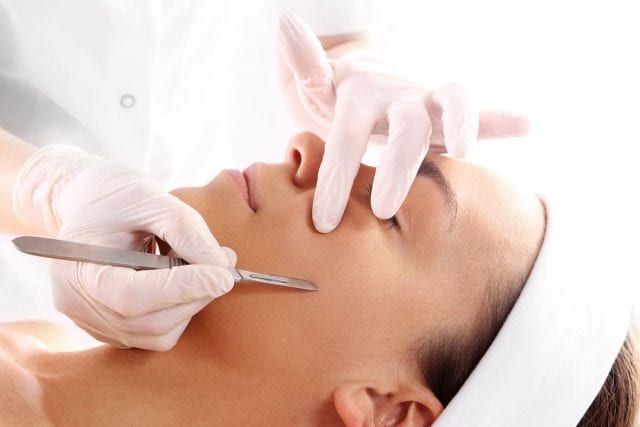 Dermaplaning Treatment: Precise exfoliation and facial hair removal methods using controlled strokes of a medical instrument.